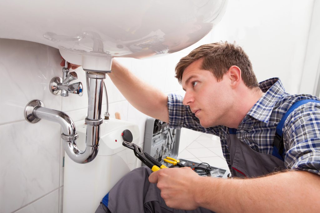 Plumber Fixing A Drain