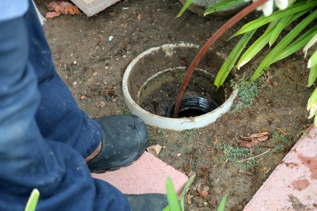 A Plumber Cleaning A Sewer Line