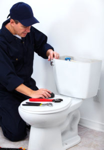 Professional-plumber-repairing-toilet-208x300