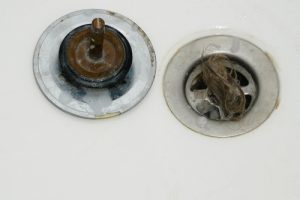 bathtub drain stopper clogged with hair