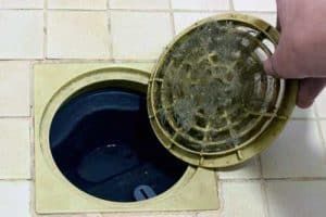 Manually removing clogged materials from shower drain