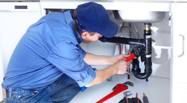 Plumbing Technician Fixing A Pipe