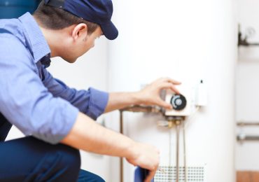 Plumbing Technican Checking Water Heater