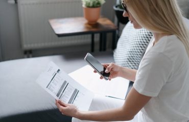 woman scanning water bill with cell phone