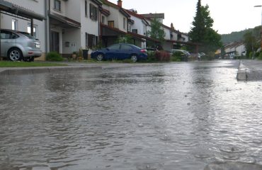 LOW ANGLE: Heavy April rainfall floods a tranquil suburban neighborhood.