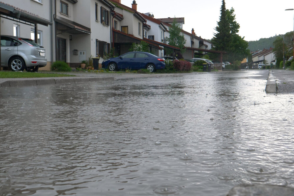 LOW ANGLE: Heavy April rainfall floods a tranquil suburban neighborhood.