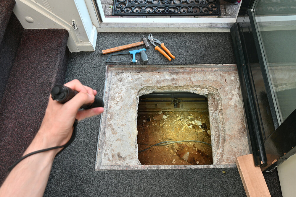 Indoor crawl space access hatch with plumbing exposed