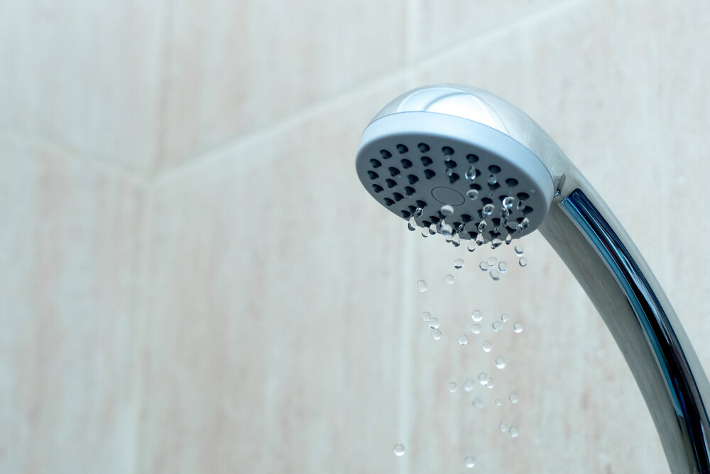 Shower head with low water stream. Broken shower in the bashroom